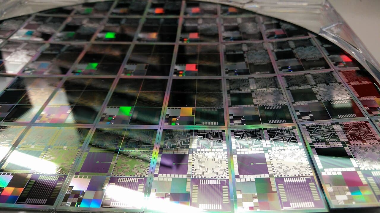 A reflective semiconductor wafer representing the AI chip and technology stocks in the August 14 market outlook